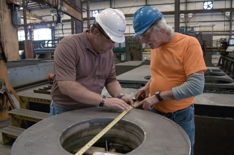 Ryerson employees measuring product